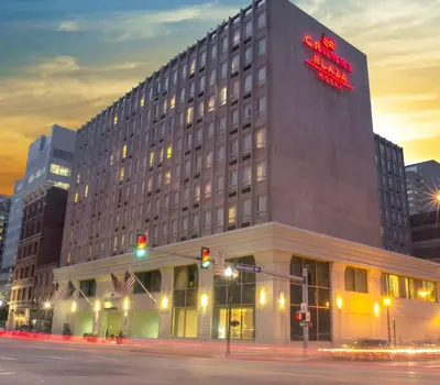 a building with a red sign on the side of it at Crowne Plaza Hotel Harrisburg-Hershey by IHG in Harrisburg