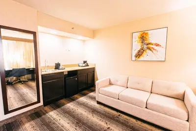 a living room with a couch and a sink at Crowne Plaza Hotel Harrisburg-Hershey by IHG in Harrisburg