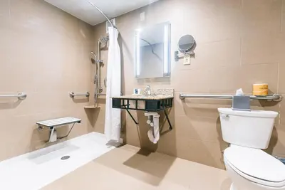 a bathroom with a toilet and a sink at Crowne Plaza Hotel Harrisburg-Hershey by IHG in Harrisburg