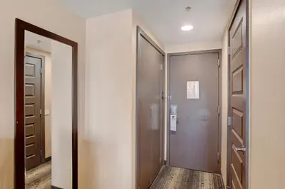a hallway with a door leading to a walk in closet at Crowne Plaza Hotel Harrisburg-Hershey by IHG in Harrisburg