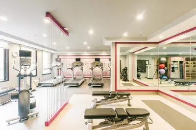 a gym with a row of treadmills and machines at Crowne Plaza Hotel Harrisburg-Hershey by IHG in Harrisburg