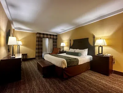a hotel room with a large bed and two lamps at Red Lion Hotel Harrisburg Hershey in Harrisburg