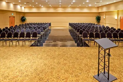 an empty auditorium with chairs and a table at Red Lion Hotel Harrisburg Hershey in Harrisburg