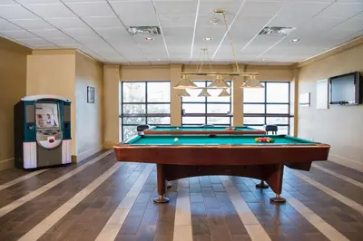 a billiard room with a pool table and a machine at Red Lion Hotel Harrisburg Hershey in Harrisburg