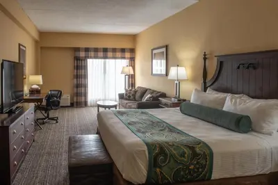 a hotel room with a large bed and a couch at Red Lion Hotel Harrisburg Hershey in Harrisburg