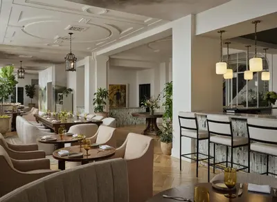 a restaurant with tables and chairs and a bar at The Bellevue Hotel, in the Unbound Collection by Hyatt in Philadelphia