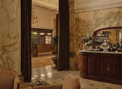 a room with a mirror and a bar in a building at The Bellevue Hotel, in the Unbound Collection by Hyatt in Philadelphia