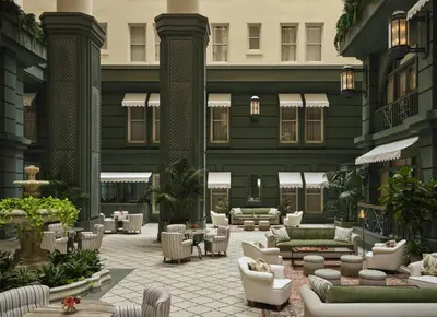 an outdoor patio with couches and tables and chairs at The Bellevue Hotel, in the Unbound Collection by Hyatt in Philadelphia