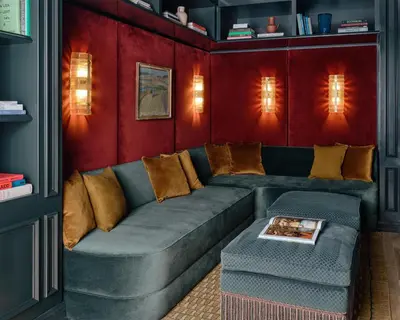 a living room with a gray couch and red walls at The Bellevue Hotel, in the Unbound Collection by Hyatt in Philadelphia