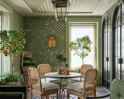 a room with a table and chairs and plants at The Bellevue Hotel, in the Unbound Collection by Hyatt in Philadelphia