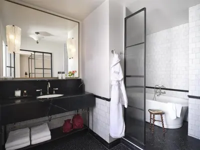 a bathroom with a sink and a mirror at The Bellevue Hotel, in the Unbound Collection by Hyatt in Philadelphia