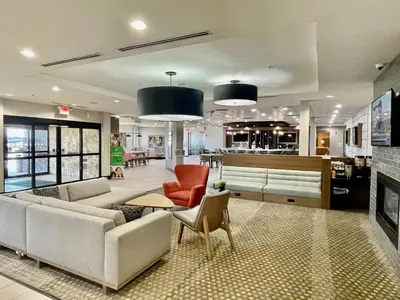a living room with a couch and chairs and a table at Holiday Inn Lansdale-Hatfield by IHG in Kulpsville