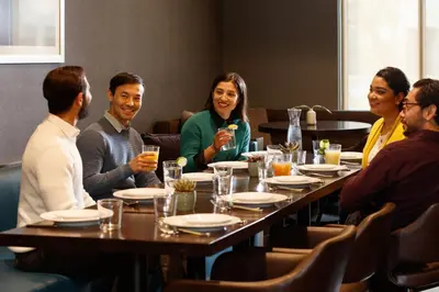a group of people sitting around a table in a restaurant at Holiday Inn Lansdale-Hatfield by IHG in Kulpsville