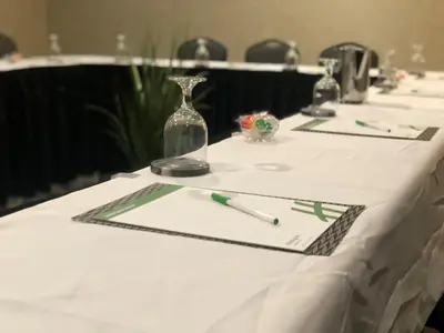 a table with a white table cloth with a pen on it at Holiday Inn Lansdale-Hatfield by IHG in Kulpsville