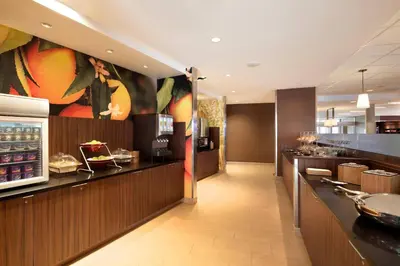 a restaurant with a bar with a buffet at Fairfield Inn & Suites by Marriott Lancaster East at The Outlets in Lancaster