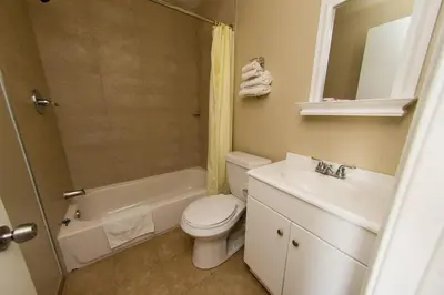a bathroom with a toilet and a sink and a shower at Scottish Inn and Suites - Bensalem-Philadelphia in Bensalem