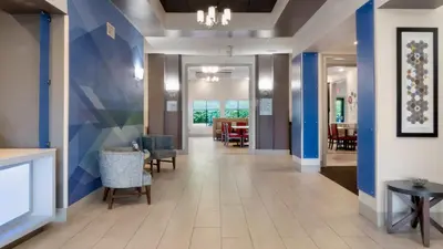 a hallway of a hospital with chairs and tables at Holiday Inn Express Hotel & Suites Newton Sparta by IHG in Newton