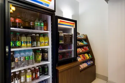 a refrigerator filled with lots of different types of drinks at Holiday Inn Express Hotel & Suites Newton Sparta by IHG in Newton