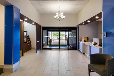 an office lobby with a waiting area and a chair at Holiday Inn Express Hotel & Suites Newton Sparta by IHG in Newton