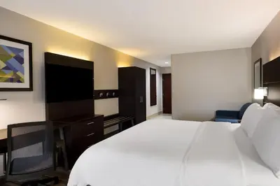 a hotel room with a large white bed and a desk at Holiday Inn Express Hotel & Suites Newton Sparta by IHG in Newton