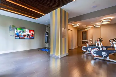 a gym with several treadmills and exercise bikes at Global Luxury Suites at Newport in Jersey City