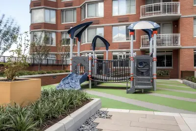 a playground in front of a building at Global Luxury Suites at Newport in Jersey City