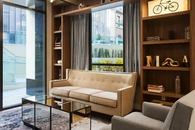 a living room with a couch and a glass table at Fairfield Inn & Suites by Marriott New York Manhattan/Central Park in New York
