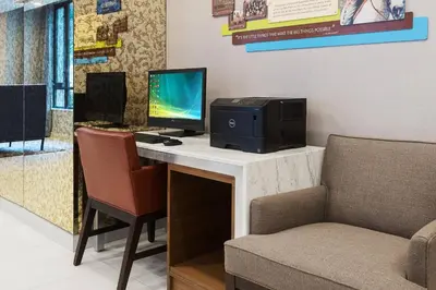 a desk with a computer on it with a chair at Fairfield Inn & Suites by Marriott New York Manhattan/Central Park in New York