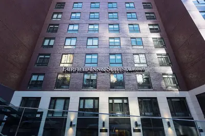 a tall brick building with a sign on it at Fairfield Inn & Suites by Marriott New York Manhattan/Central Park in New York