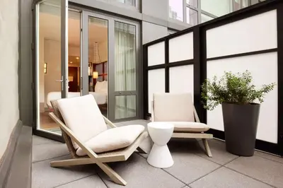 two chairs and a plant on a balcony at Arlo NoMad in New York