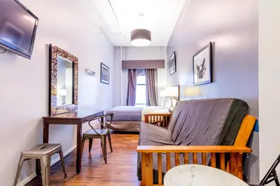 a living room with a couch and a table at Hotel 309 in New York