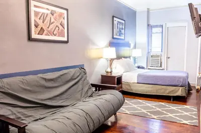 a living room with a couch and a bed at Hotel 309 in New York