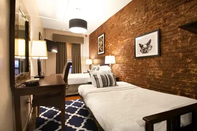 a hotel room with two beds and a brick wall at Hotel 309 in New York