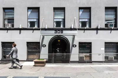 a man walking down a street in front of a building at Hotel 309 in New York
