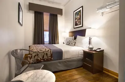 a hotel room with a bed and a chair at Hotel 309 in New York