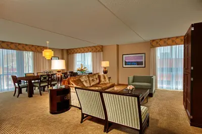 a living room with a couch and a dining room at Heldrich Hotel and Conference Center in New Brunswick