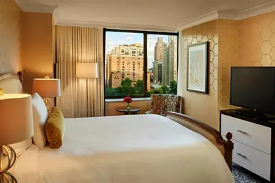 a hotel room with a large bed and a large window at The Rittenhouse Hotel in Philadelphia
