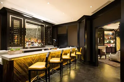 a bar with yellow bar stools in a restaurant at The Rittenhouse Hotel in Philadelphia