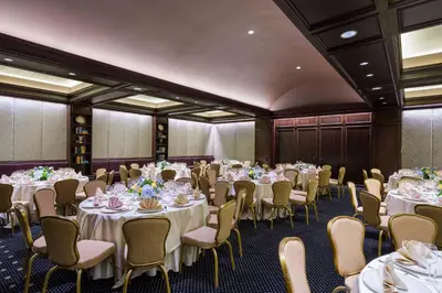 a room filled with tables and chairs with white tablecloths at The Rittenhouse Hotel in Philadelphia