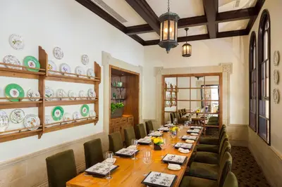 a dining room with a long table and chairs at The Rittenhouse Hotel in Philadelphia