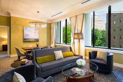 a living room with a couch and chairs and a table at The Rittenhouse Hotel in Philadelphia