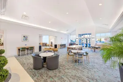 a large room with tables and chairs and tables at Homewood Suites by Hilton East Rutherford - Meadowlands, NJ in East Rutherford