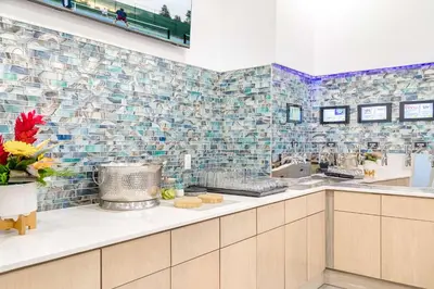 a kitchen with blue mosaic tiles on the wall at Homewood Suites by Hilton East Rutherford - Meadowlands, NJ in East Rutherford