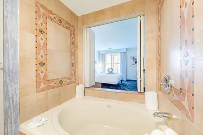 a bathroom with a tub and a large window at Homewood Suites by Hilton East Rutherford - Meadowlands, NJ in East Rutherford