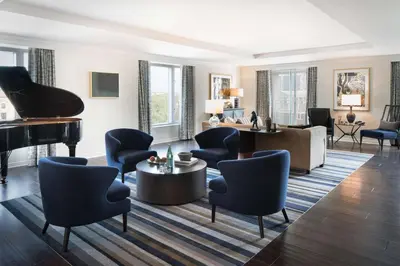 a living room with a piano and chairs at The Logan Philadelphia, Curio Collection by Hilton in Philadelphia