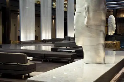 a statue of a torso in a building with benches at Hyatt Grand Central New York in New York