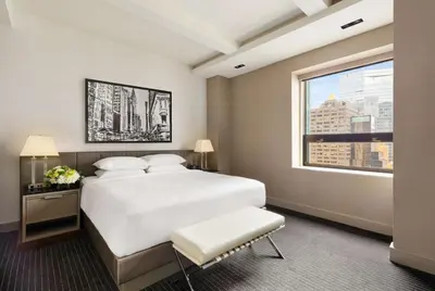 a bedroom with a large white bed and a window at Hyatt Grand Central New York in New York