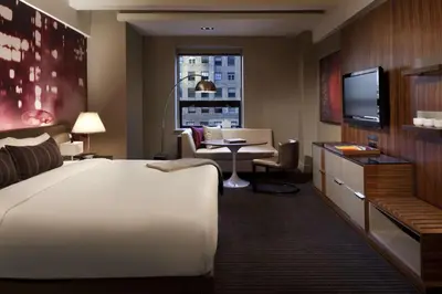 a hotel room with a large bed and a television at Hyatt Grand Central New York in New York