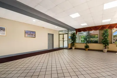 a large empty room with plants on the walls at Knights Inn Phildelphia in Philadelphia