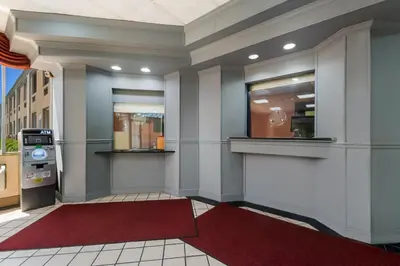 a lobby of a store with a red rug at Knights Inn Phildelphia in Philadelphia